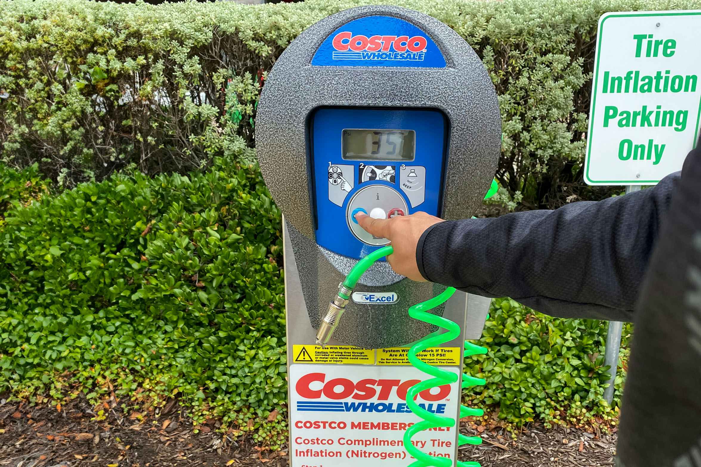 a person turning on a costco air pump 