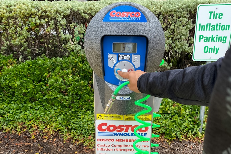 a person turning on a costco air pump 