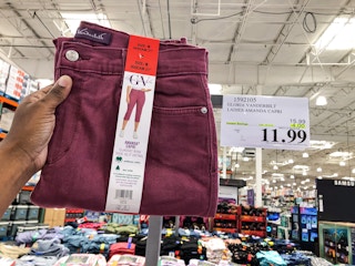 hand holding a pair of burgundy ladies capris