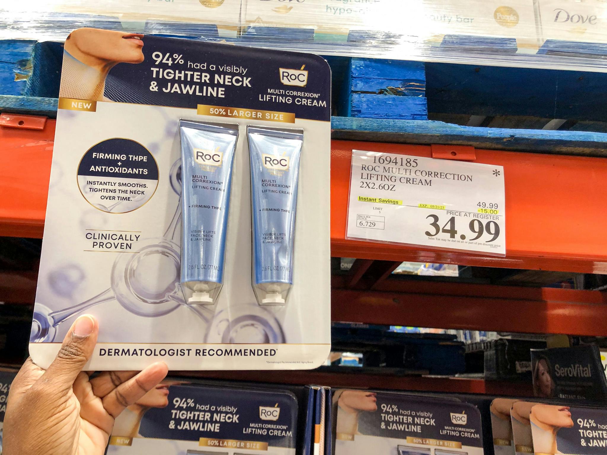 hand holding roc lifting cream by a sign for 34.99