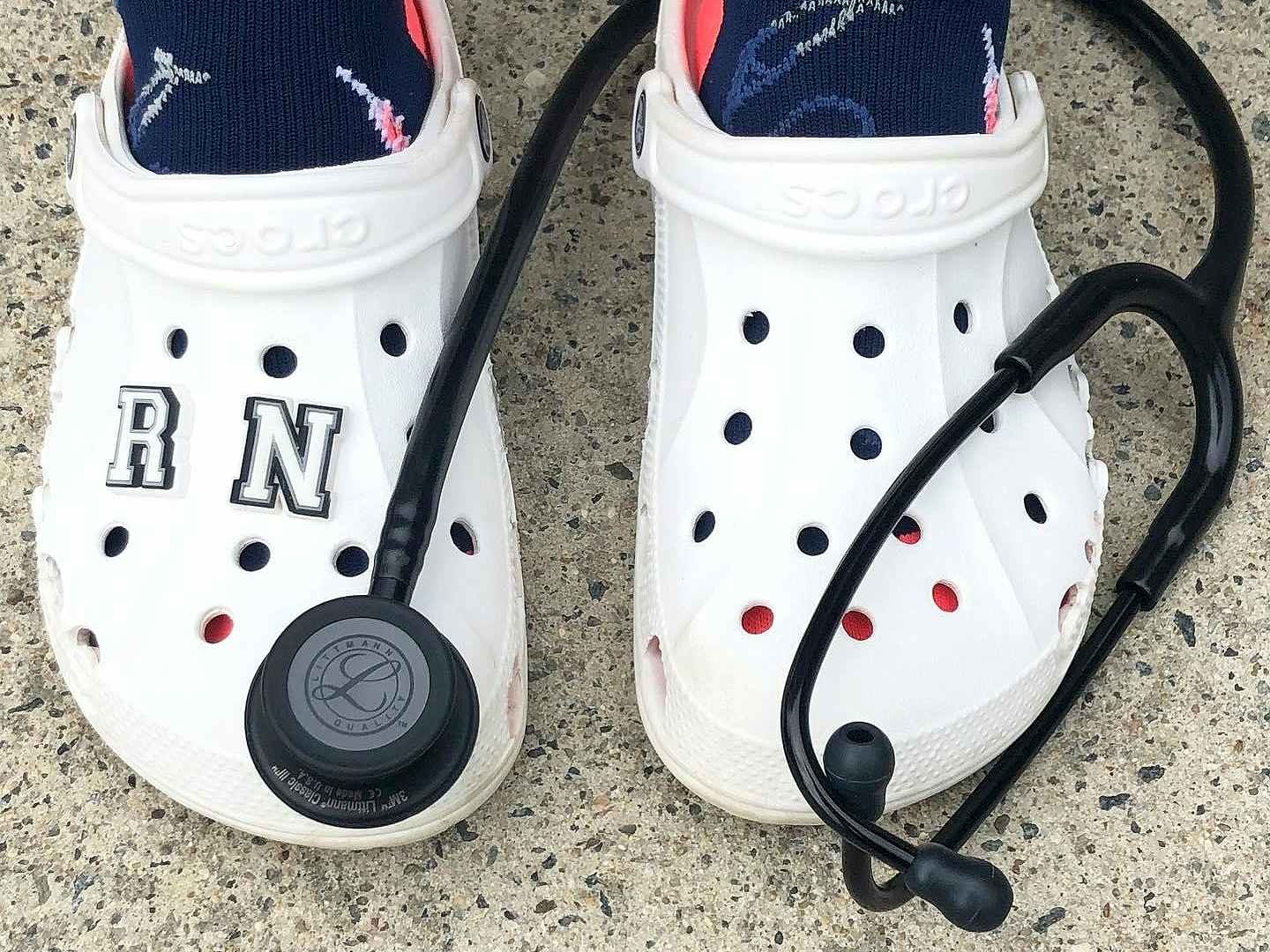 healthcare worker wearing white crocs near stethoscope