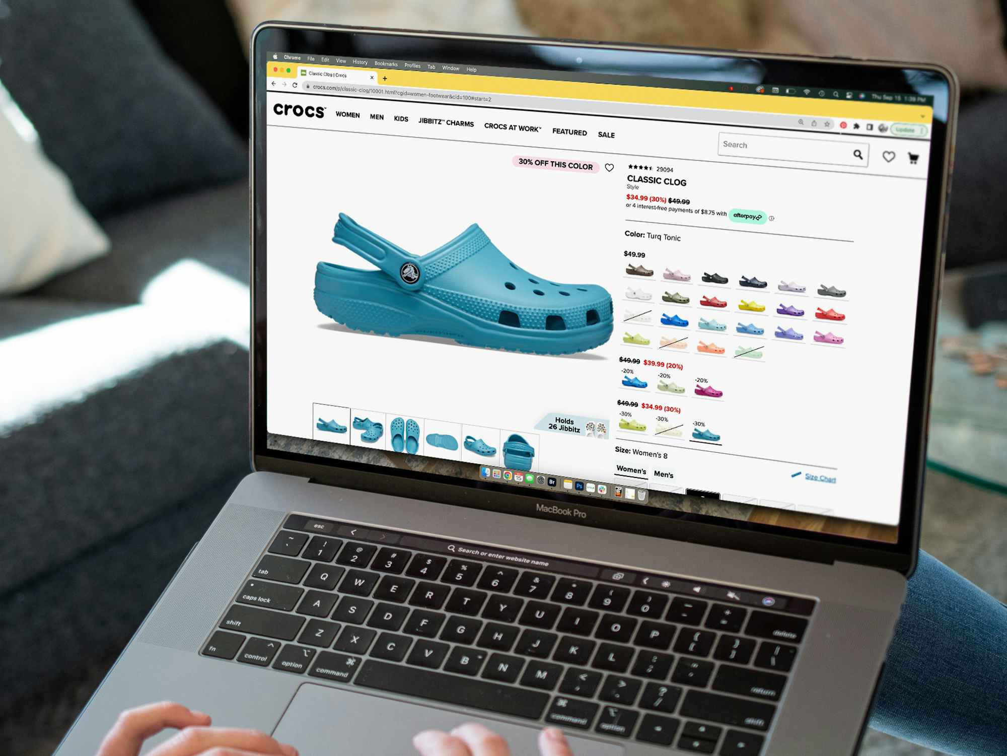 A person looking at the sale price of a pair of crocs on crocs.com.