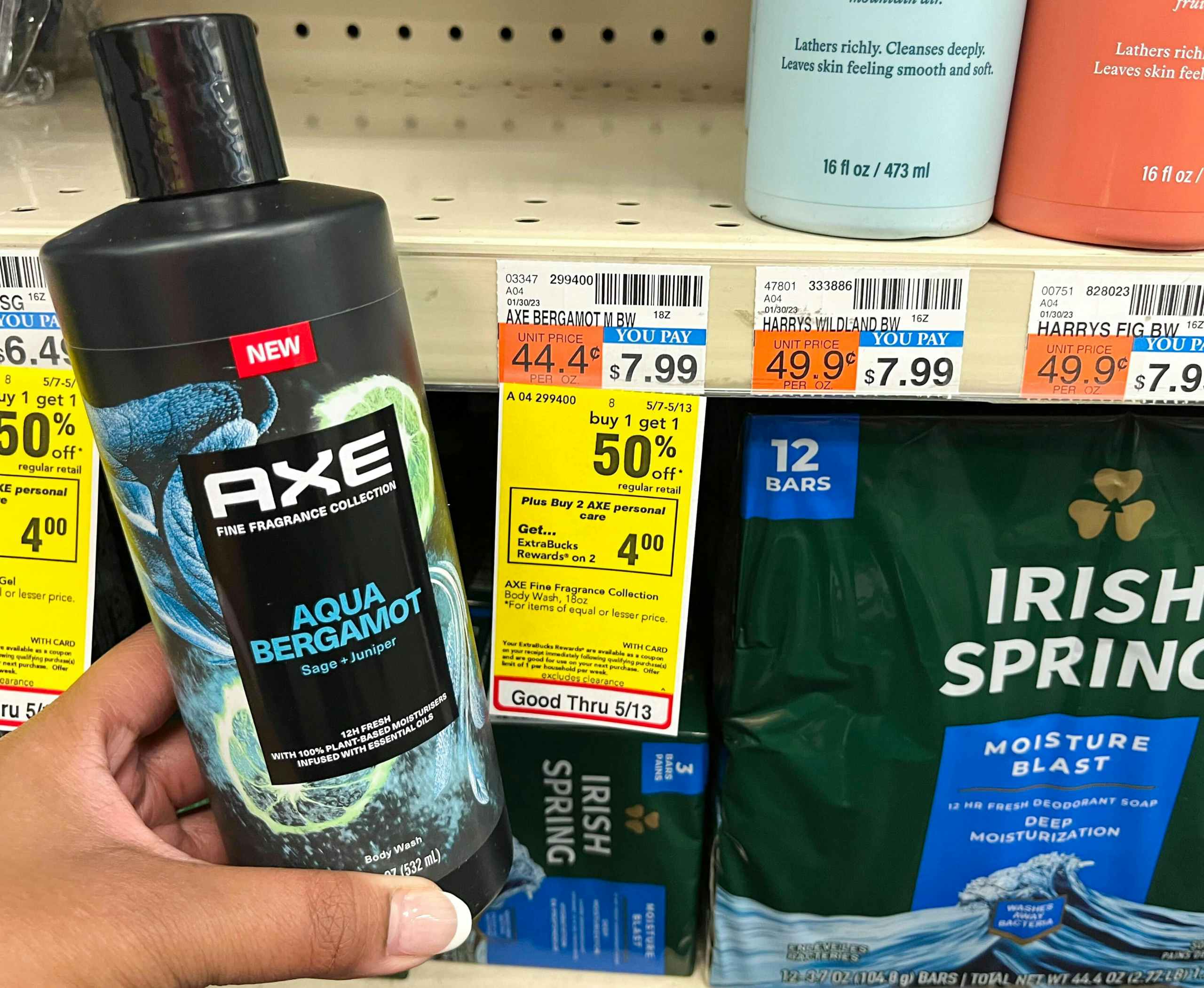 hand holding bottle of Axe body wash next to sales tag