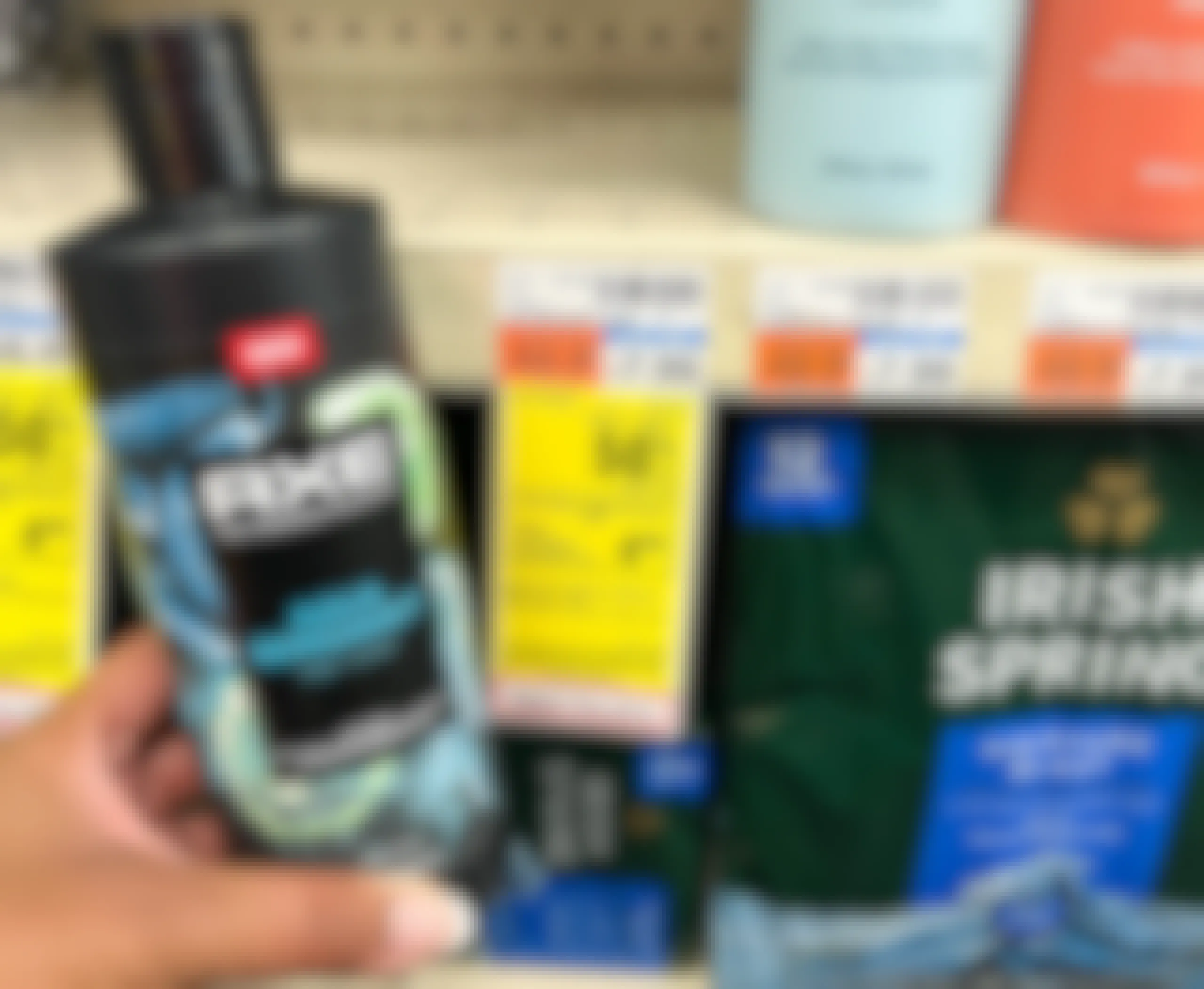 hand holding bottle of Axe body wash next to sales tag