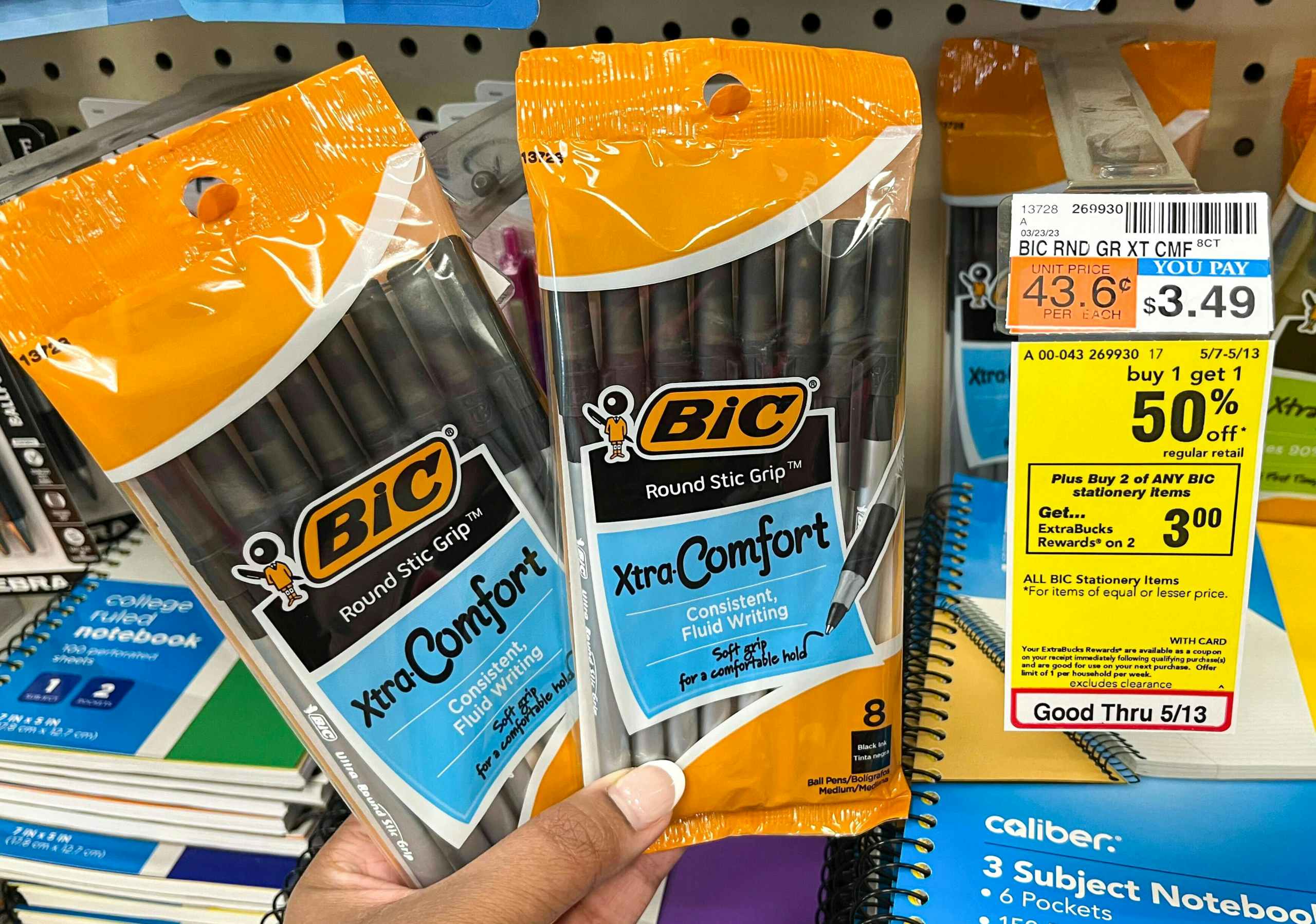hand holding two packs of BIC pens next to sales tag