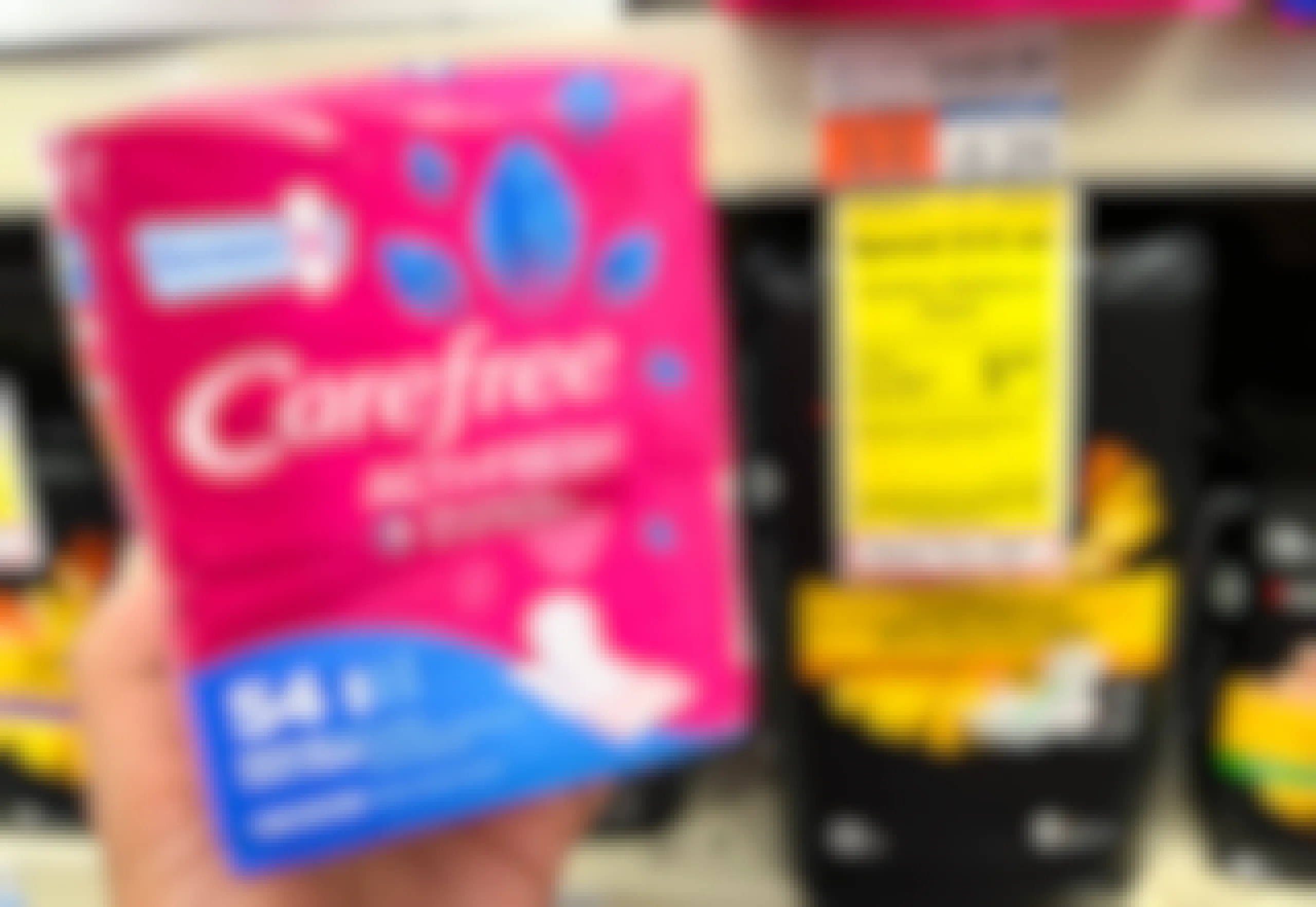 hand holding pack of Carefree liners next to sales tag