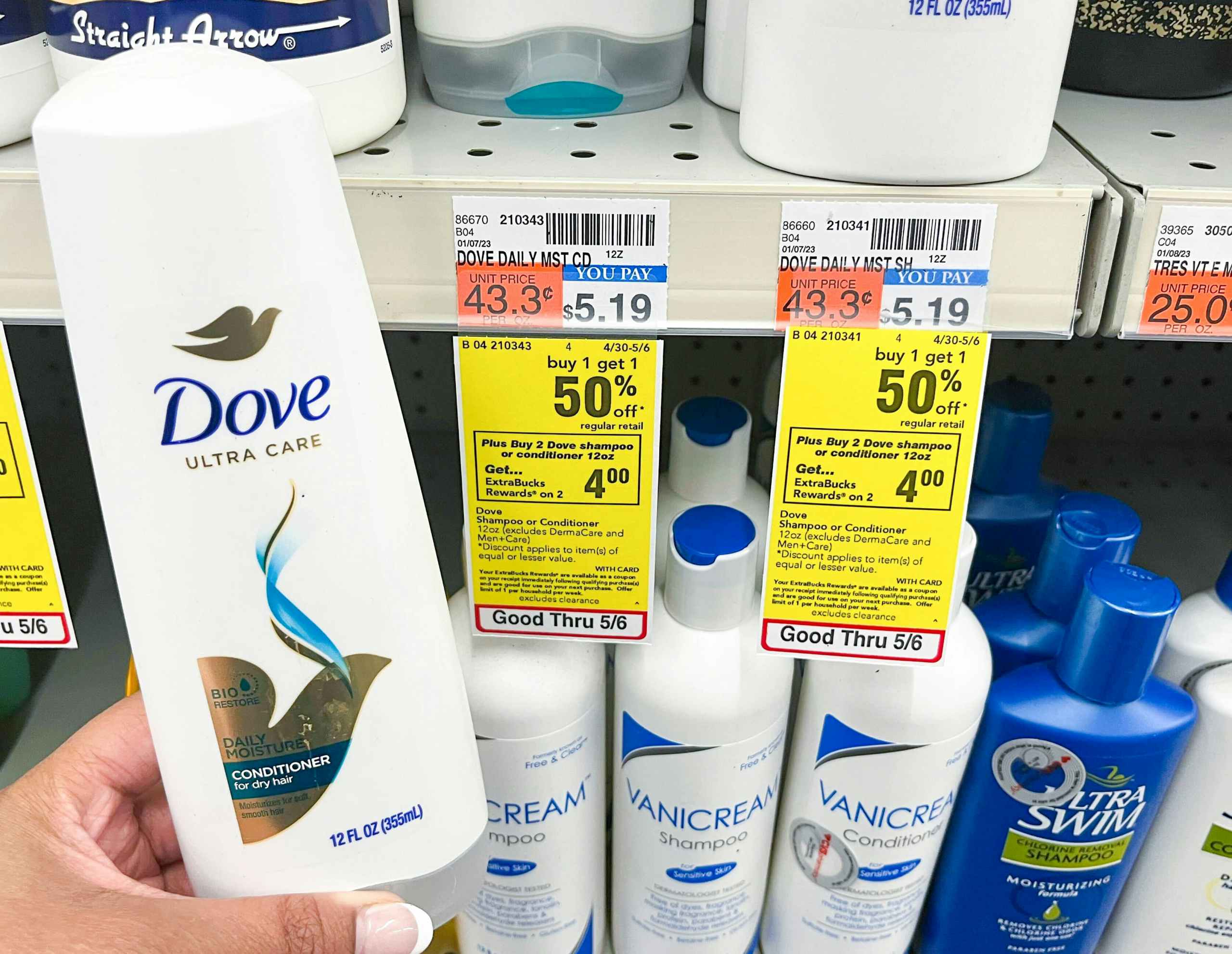 hand holding Dove conditioner next to sales tag