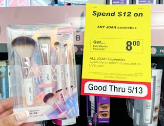 hand holding Joah makeup brush set next to sales tag