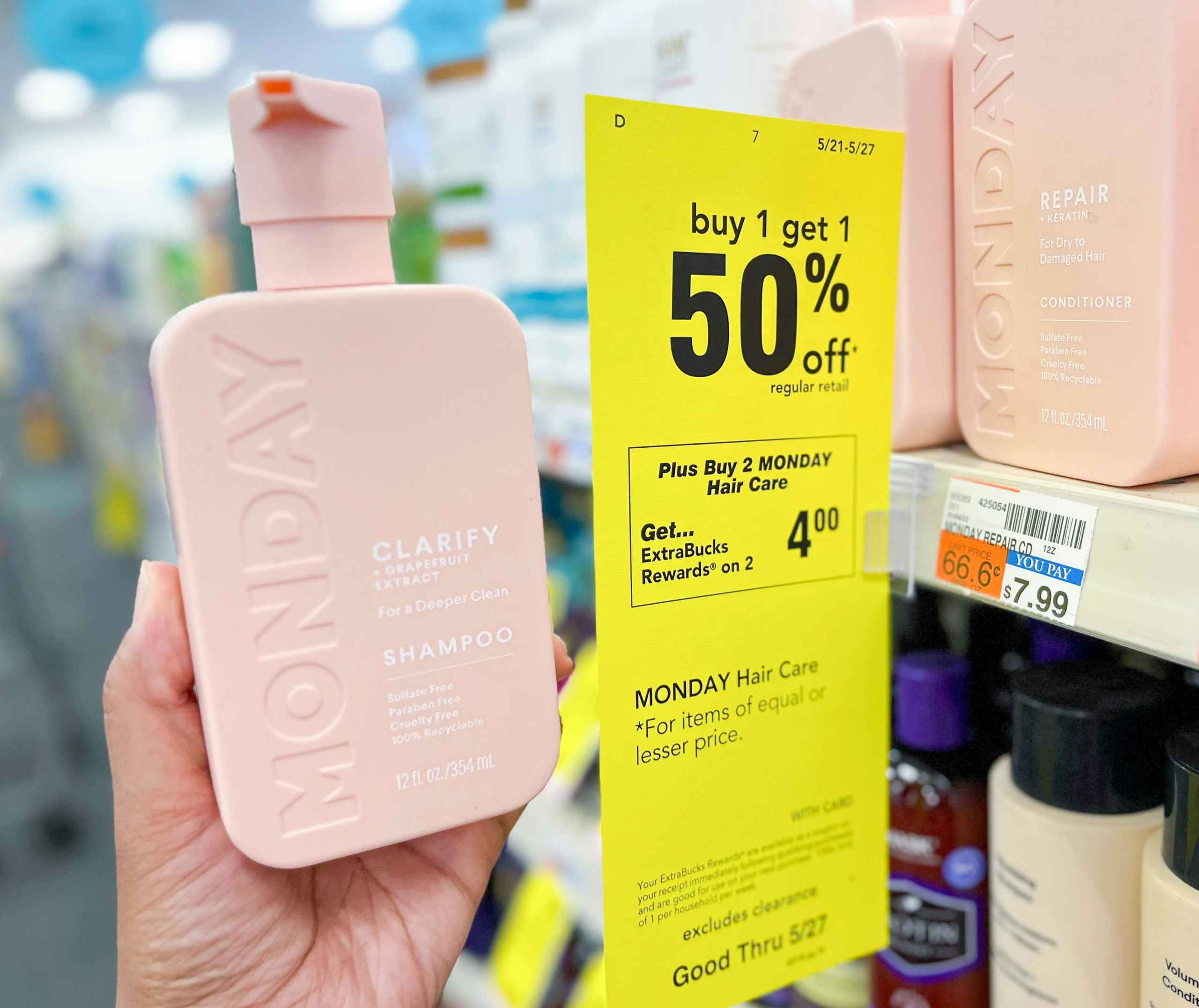 hand holding one bottle of Monday shampoo next to sales tag