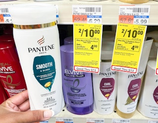 hand holding bottle of Pantene shampoo next to sales tag