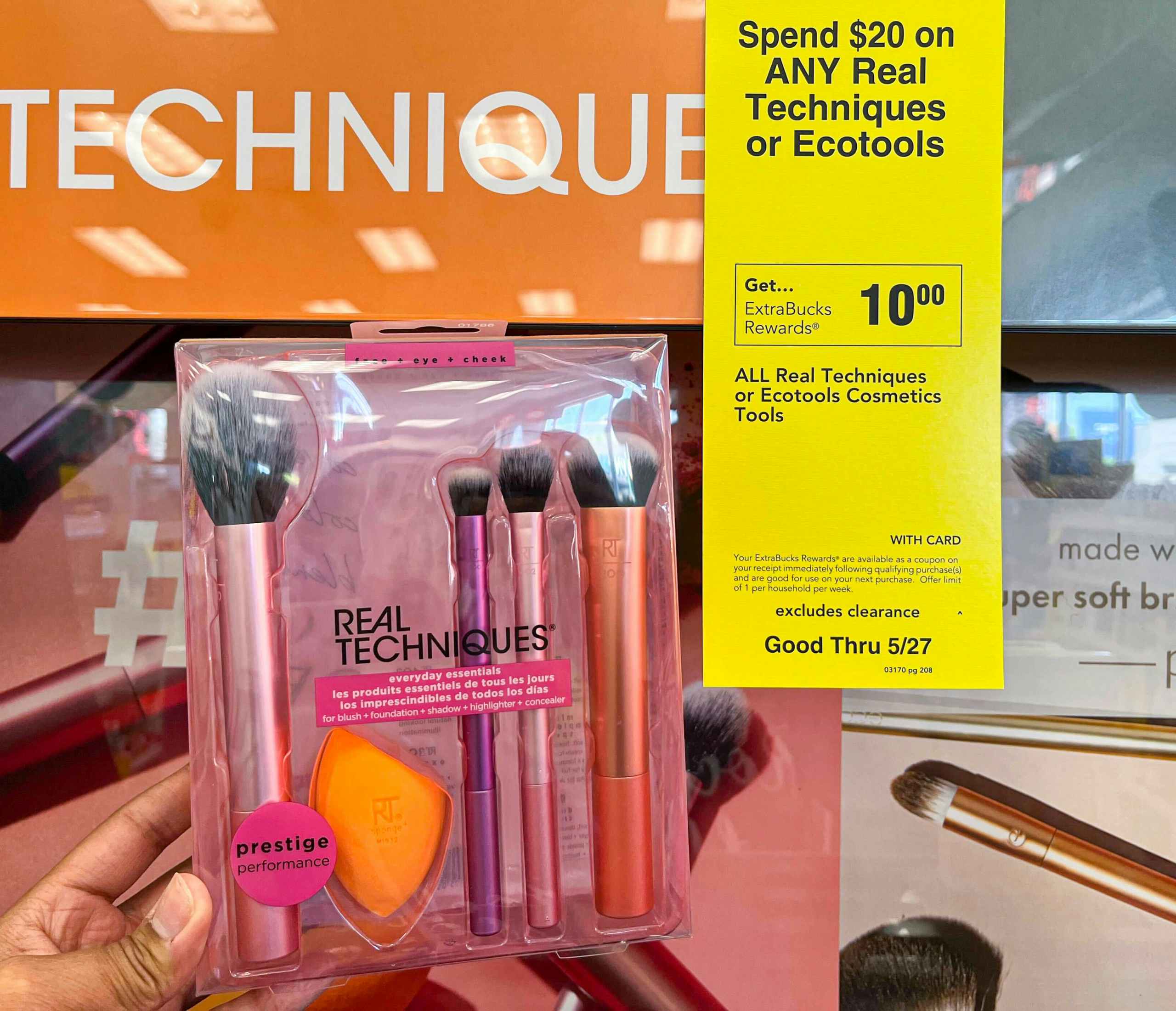 hand holding one Real Techniques brush set next to sales tag