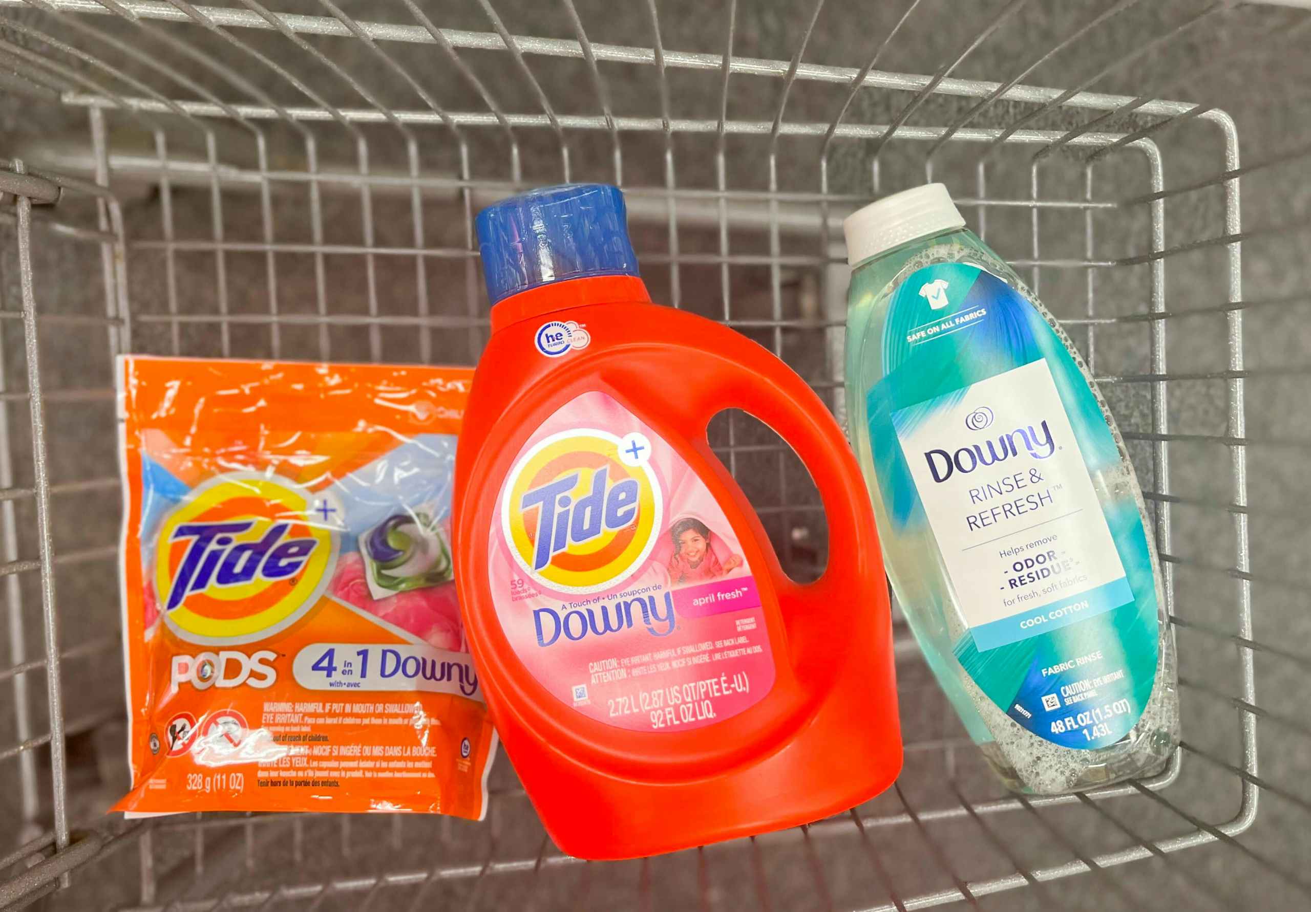one bottle of Tide liquid detergent, Downy Rinse and Refresh, and one pack of Tide pods inside shopping cart