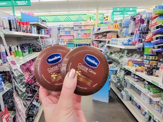 hand holding vaseline cocoa butter