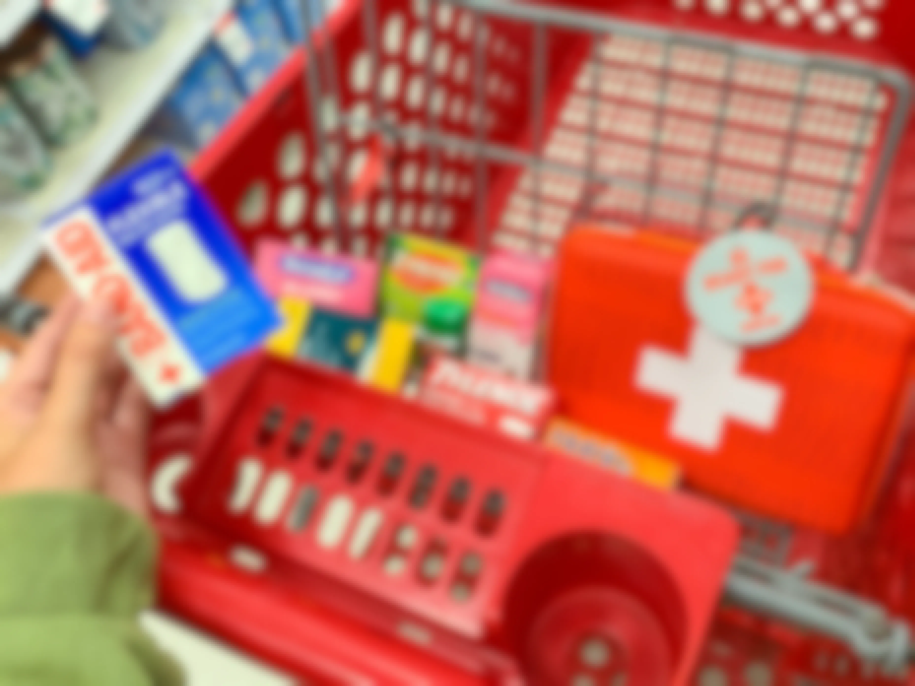 a person holding bandaids in front of a cart full of items from target