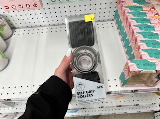 hand holding a pack of velcro hair rollers