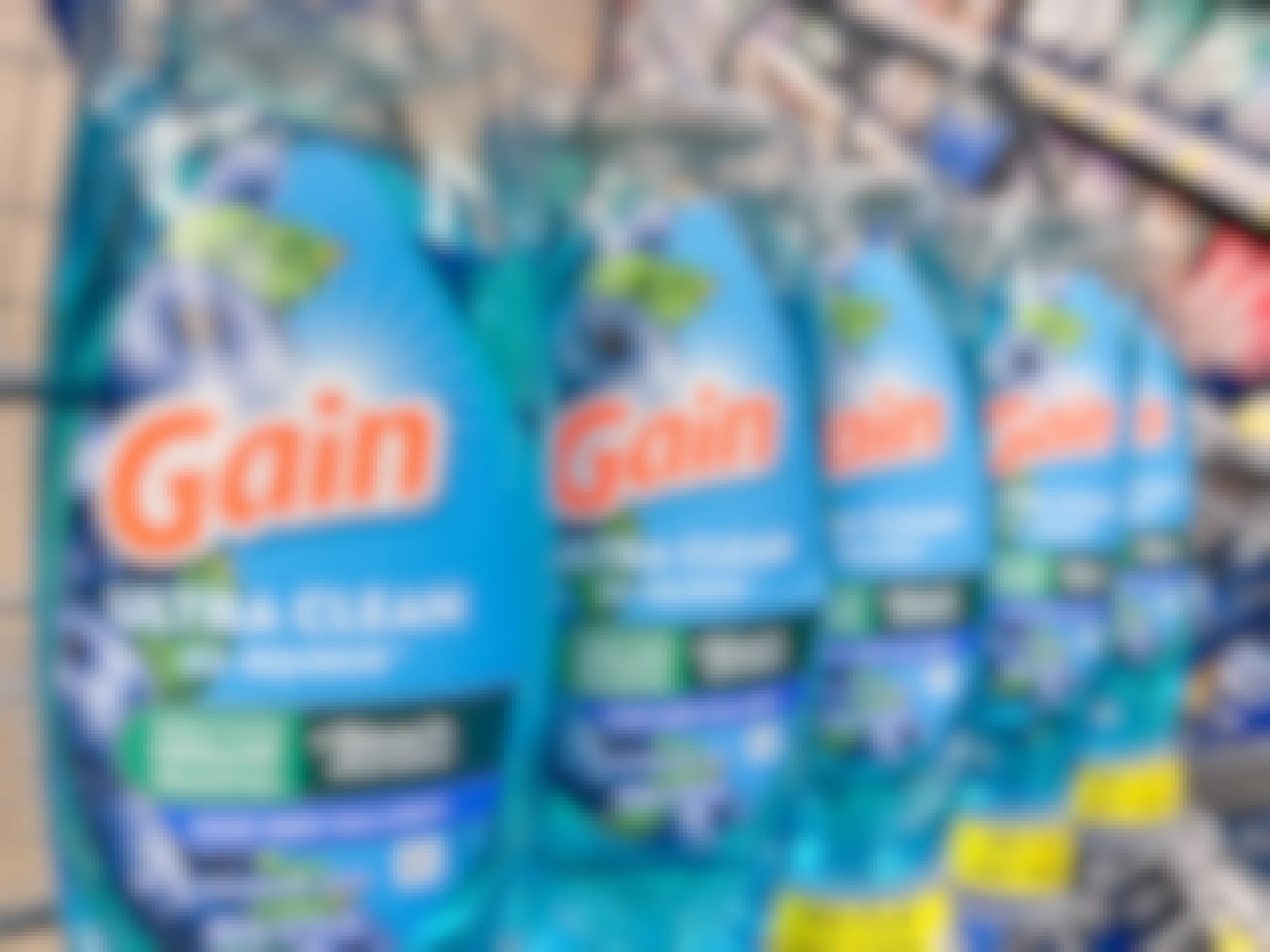 Several Gain Ultra Clean EZ Squeeze bottles sitting in a store cart.