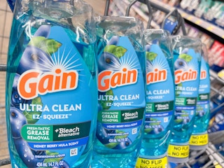 Several Gain Ultra Clean EZ Squeeze bottles sitting in a store cart.