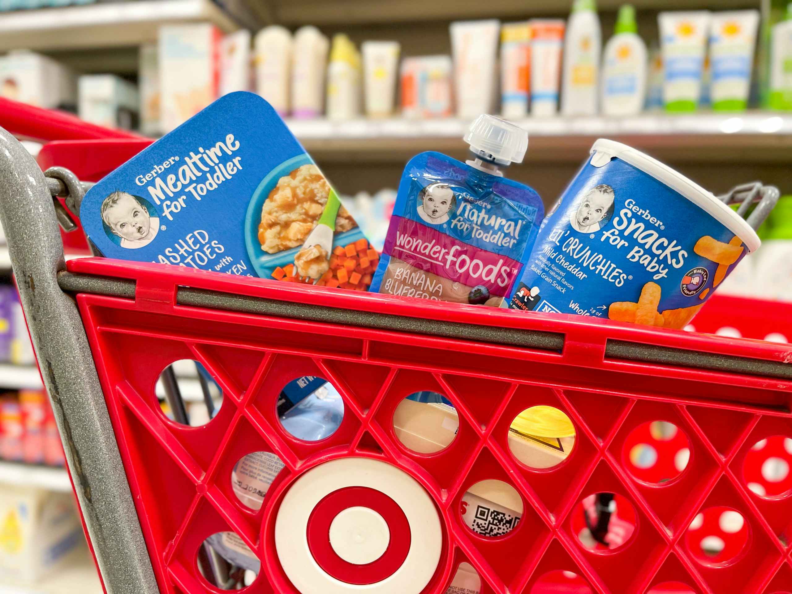 A variety of Gerber products sitting in the front of a Target shopping cart