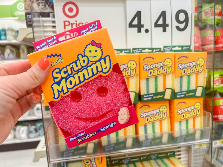a hand holding a scrub mommy at target