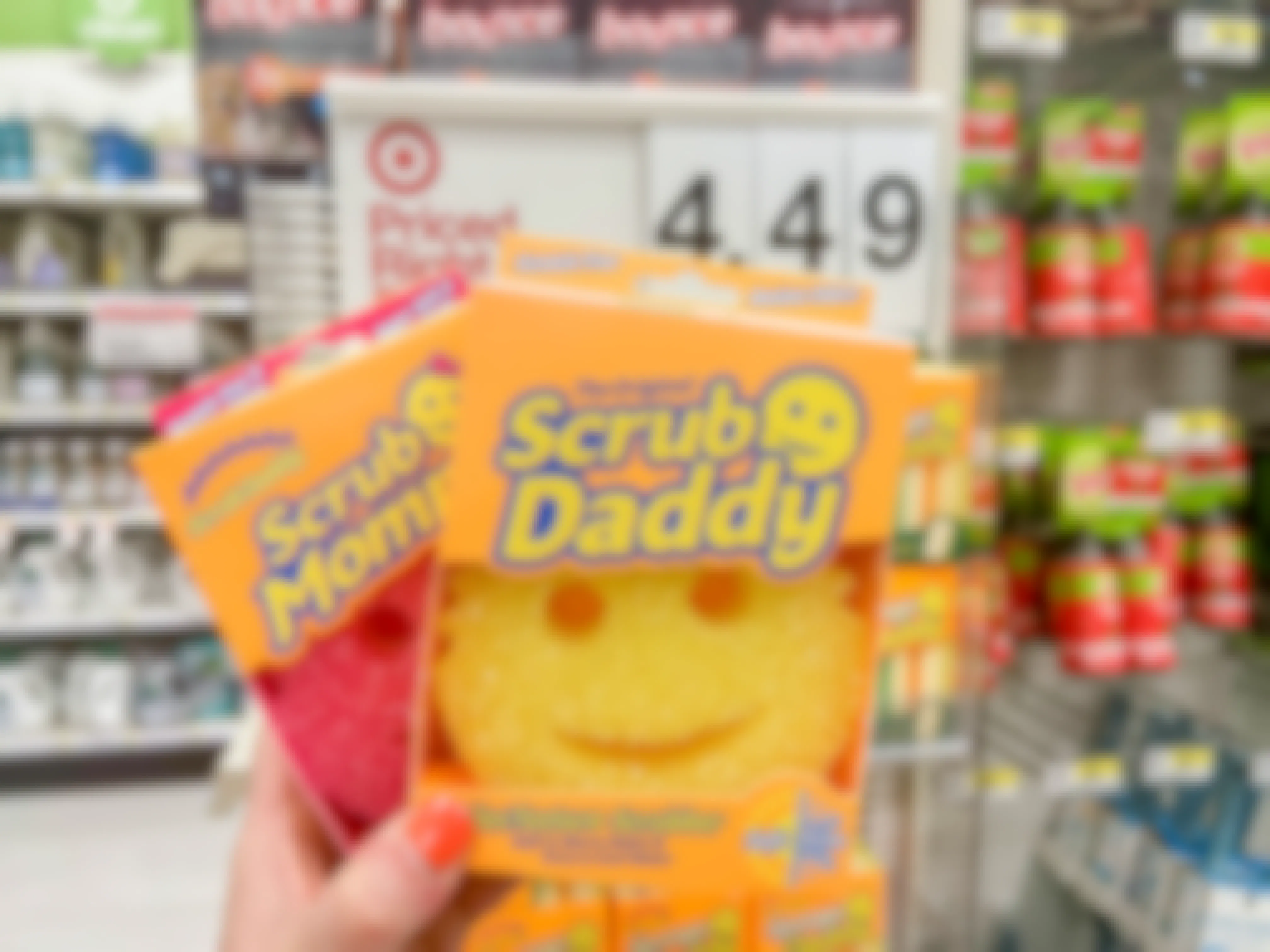 a person holding a scrub daddy and mommy at target