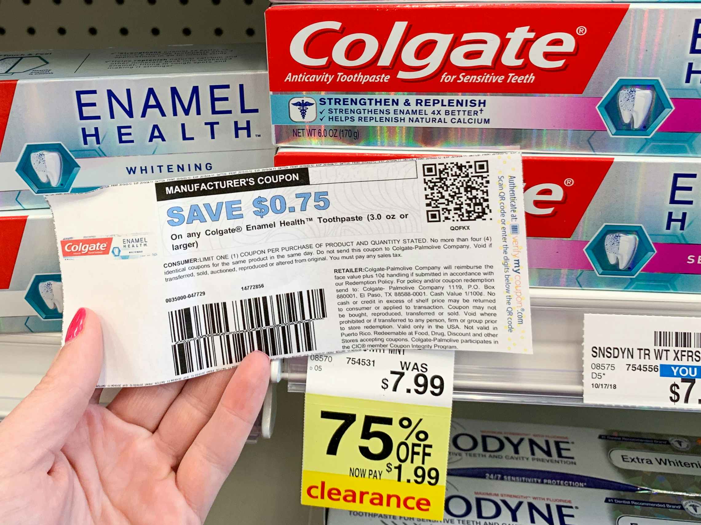 Someone holding a coupon next to a product on clearance at CVS