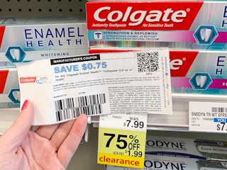 Someone holding a coupon next to a product on clearance at CVS