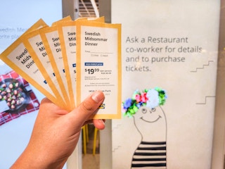 Someone holding tickets for the Ikea Swedish Midsommar Dinner