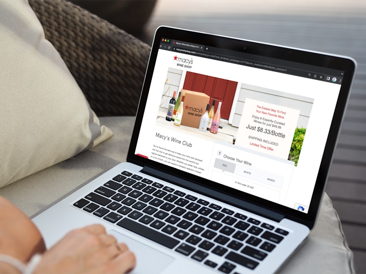 Someone looking at the Macy's Wine Club site page on a laptop