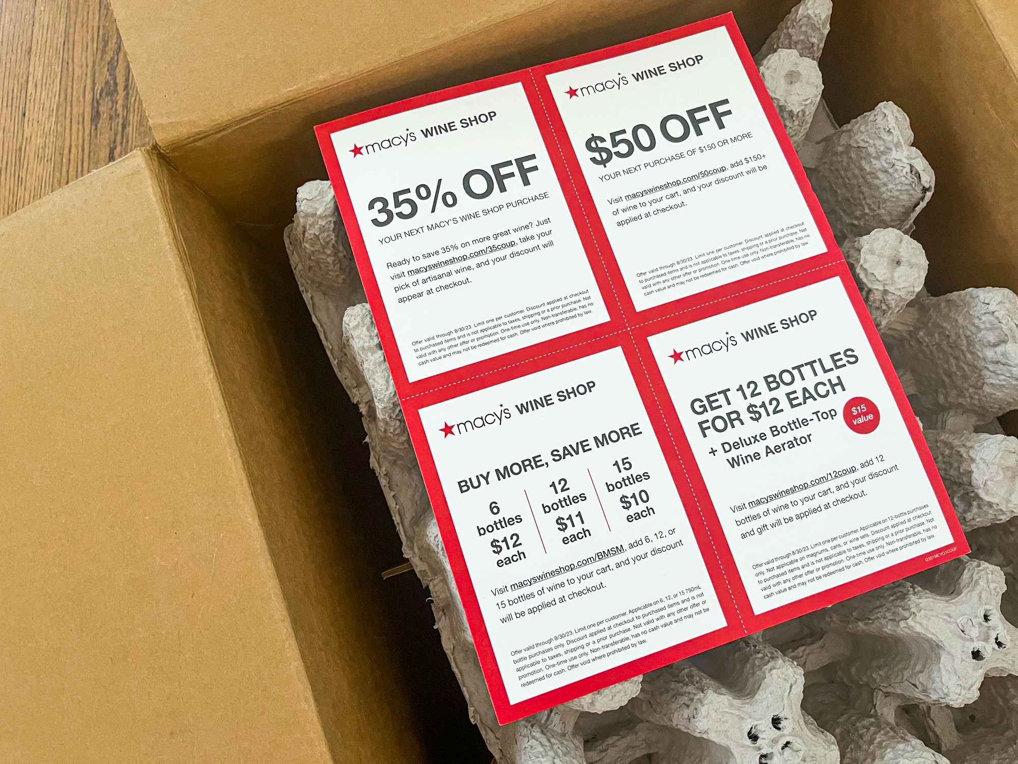 Macy's Wine Shop coupons on top of a box