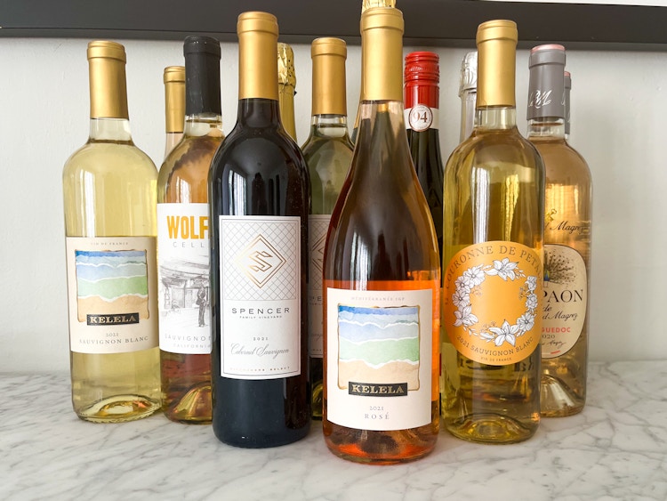 A group of bottles of wine on a counter