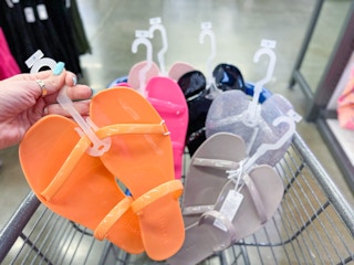 hand holding a pair of jelly sandals