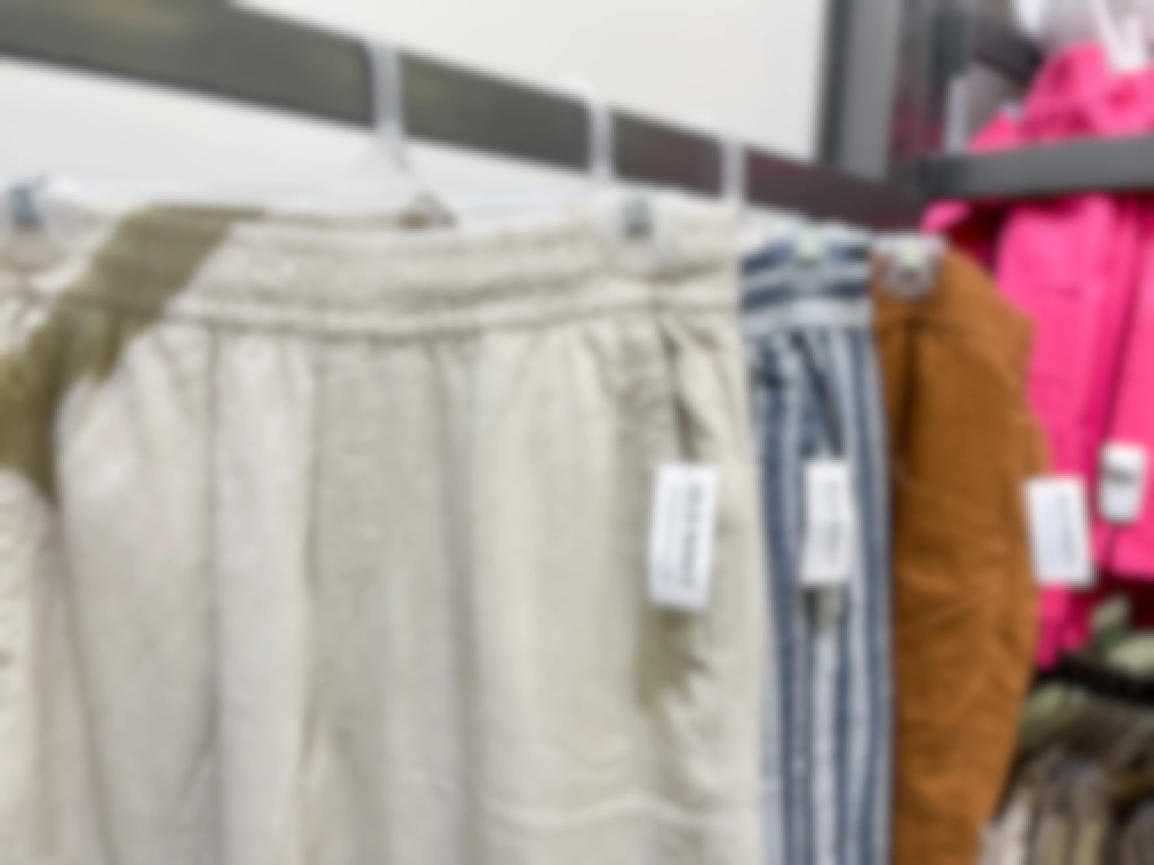 linen pants on hangers in store at old navy