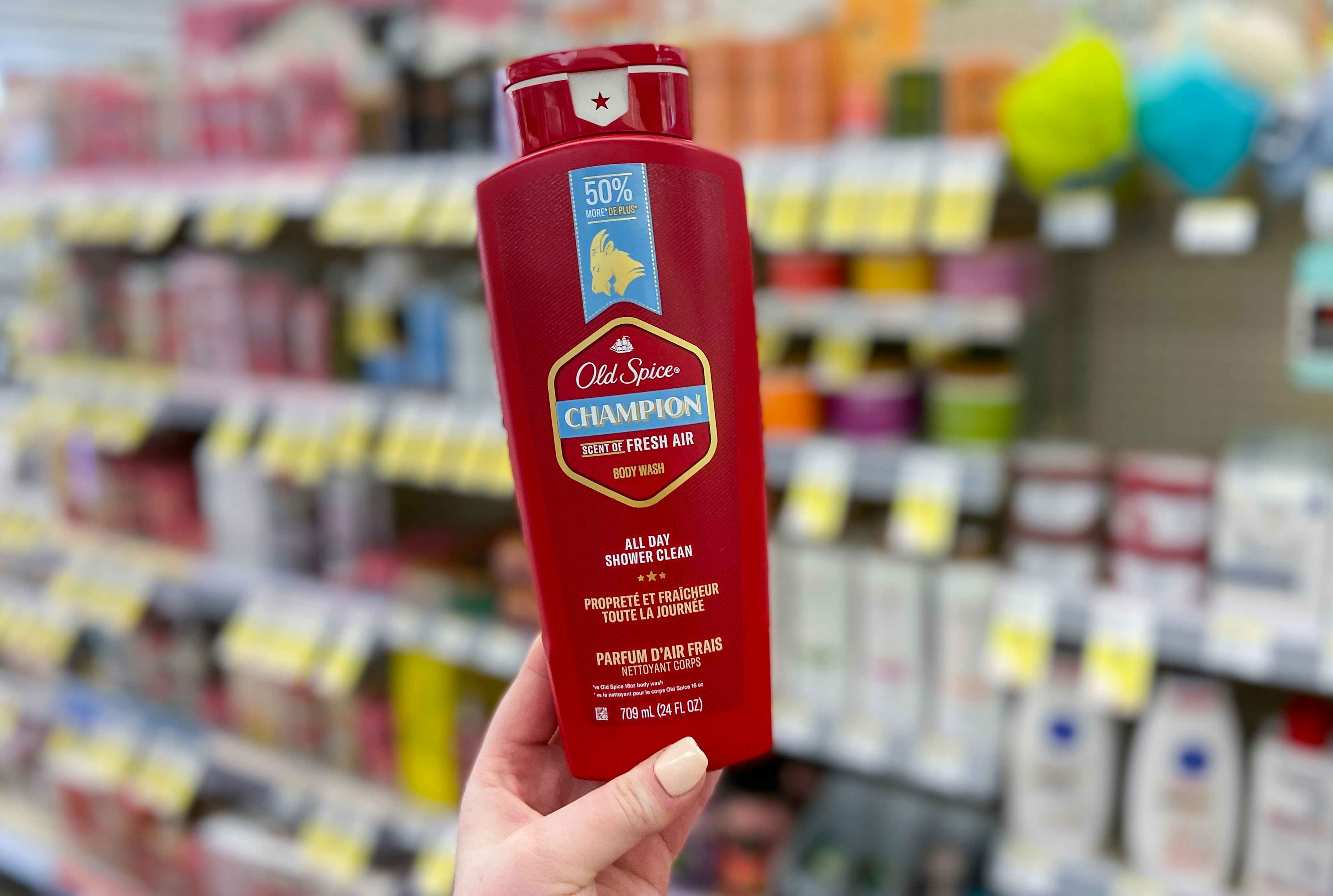 hand holding a bottle of old spice champion body wash