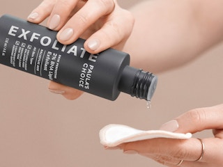 A person using Paula's Choice 2% BHA Liquid Exfoliant