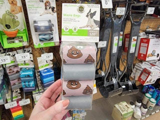 hand holding a pack of dog waste bags