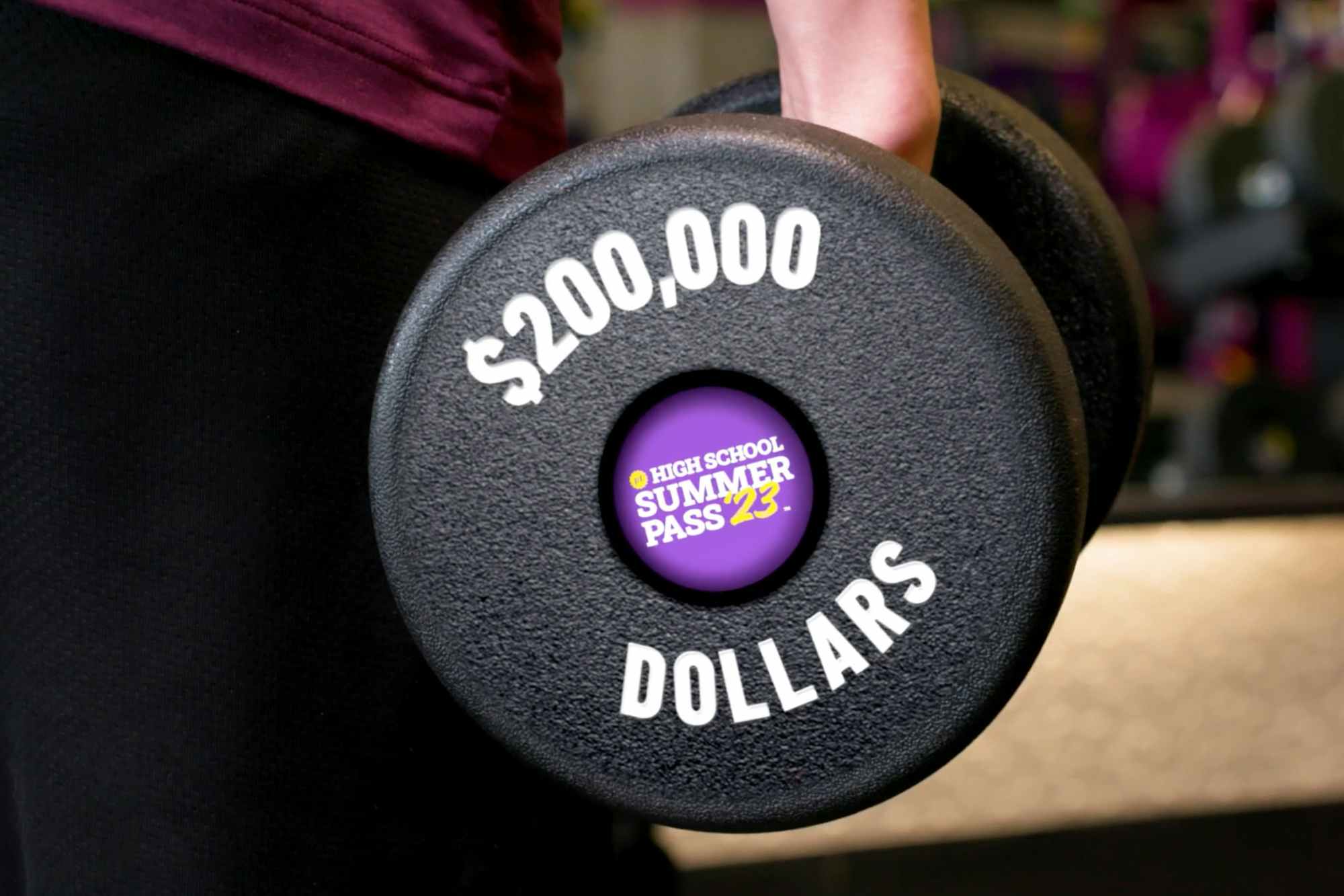 A dumbbell with $200,000 Dollars printed on it