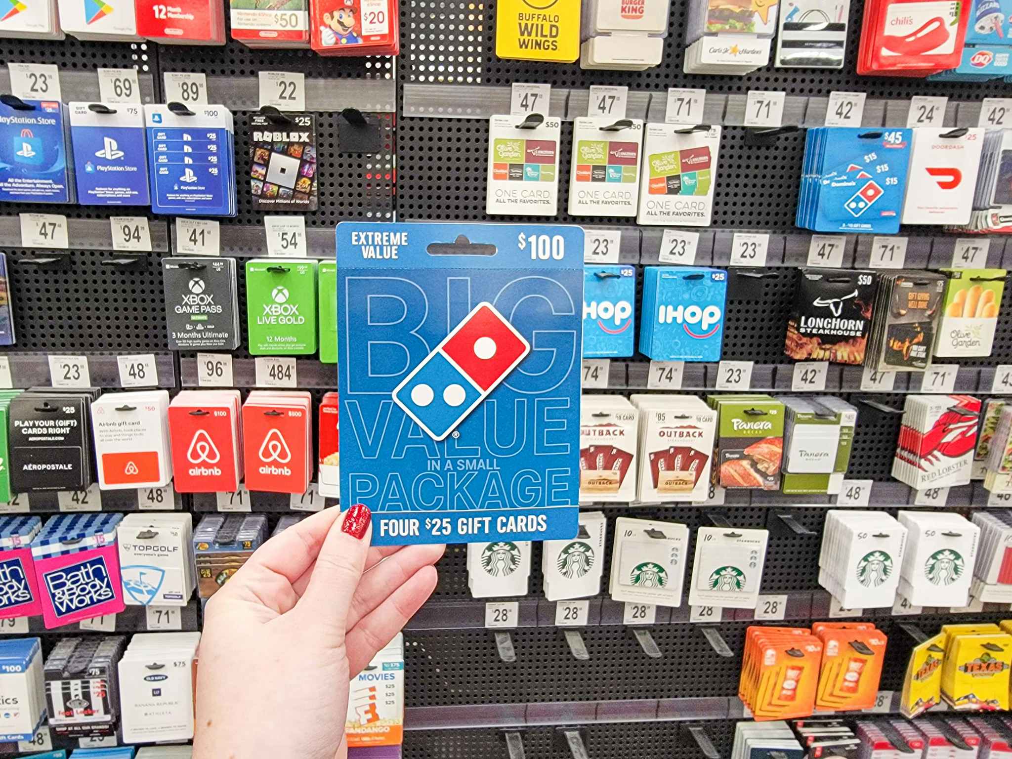 dominos gift card being held in store