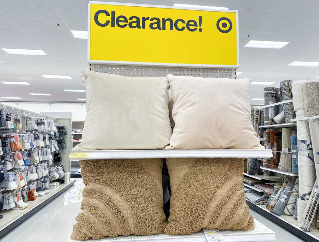 Cream and tan colored accent pillows displayed on a clearance shelf at Target