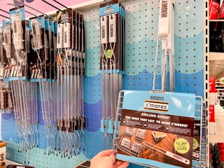 a hand holding up a s'mores grilling basket at target