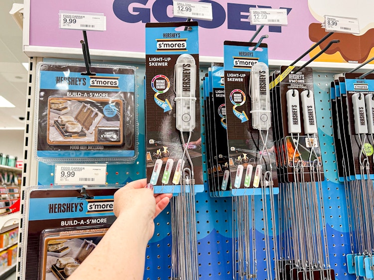 a person holding up a light up s'mores skewer at target