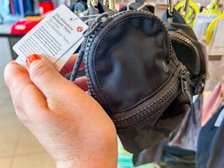 a person holding up a lululemon nano city adventurer backpack in a lululemon store