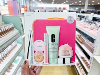 hand holding up the clinique sunny sensations box