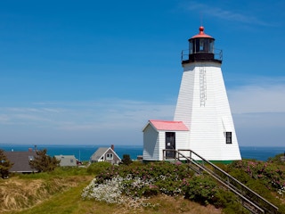 a lighthouse on the shore of a body of water