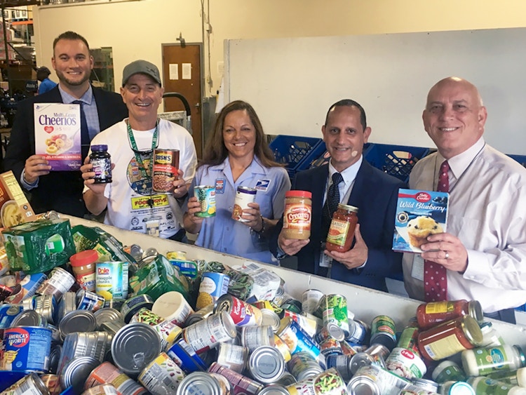 USPS employees during the Stamp Out Hunger day collecting food donations