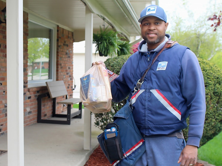 USPS employee during the Stamp Out Hunger day collecting food donations