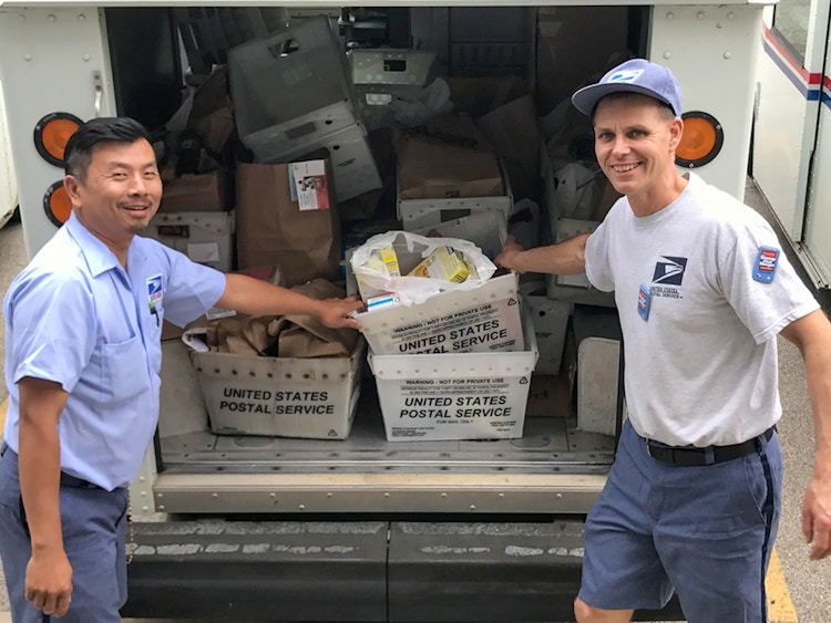 USPS employees during the Stamp Out Hunger day collecting food donations