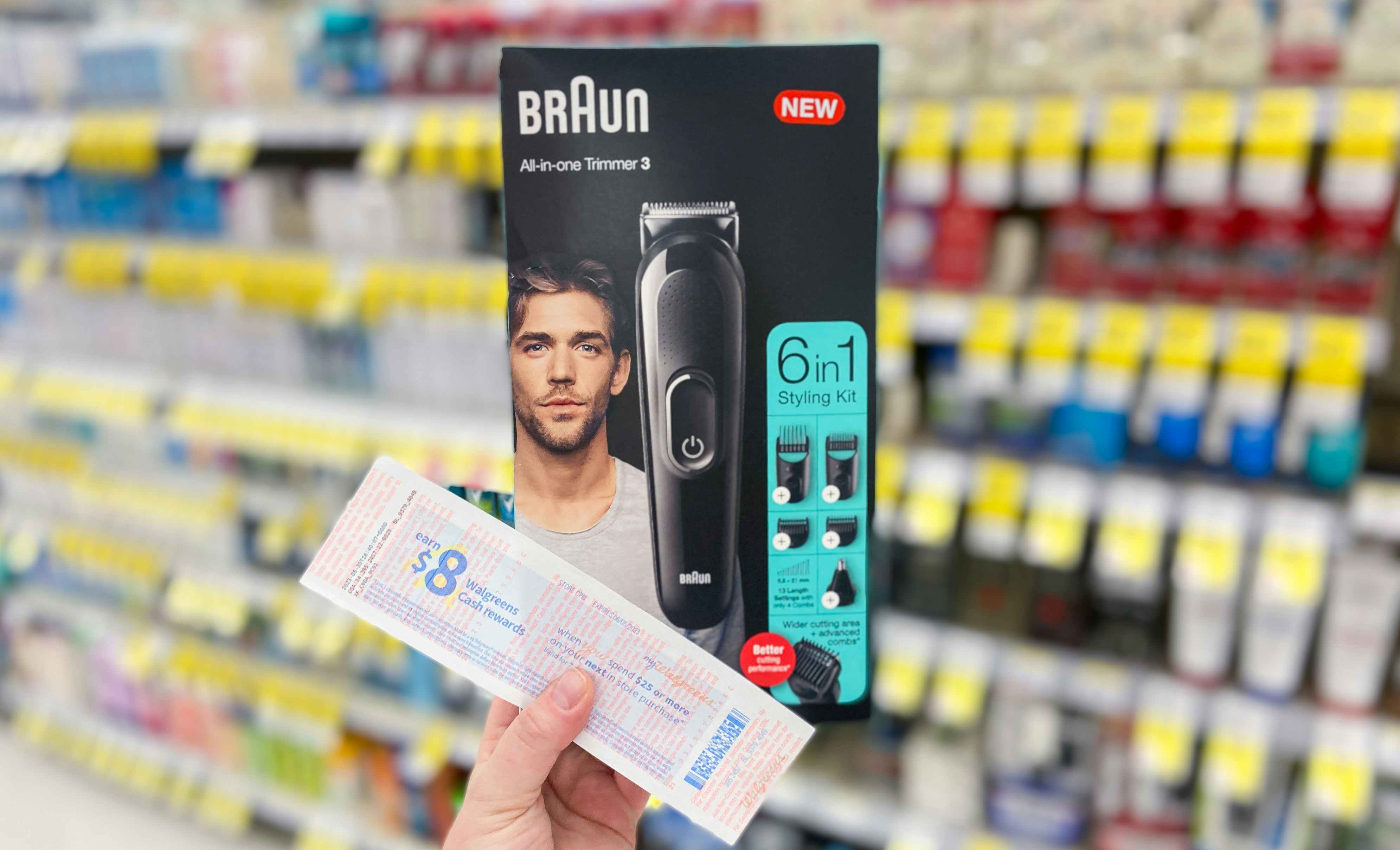 hand holding a braun 6-in-1 trimmer with a catalina coupon