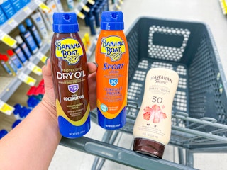hand holding Hawaiian tropic and banana boat sunscreens