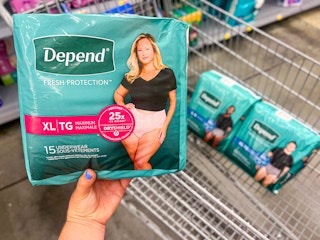 a person holding depend underwear in a walmart