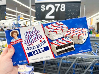 Someone holding up a box of Red White and Blue Little Debbie snack cakes in Walmart